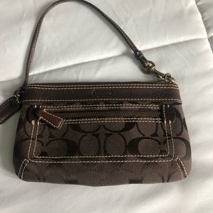 Brown Authentic Coach wristlets.